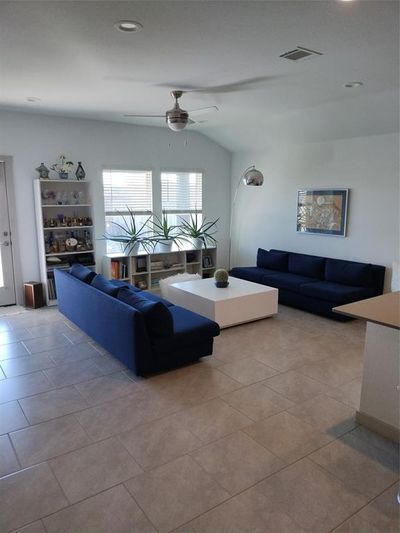 Beautiful Living room, with tile floors, ceiling fan lots of light. | Image 2