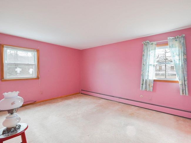 Carpeted empty room featuring a baseboard radiator | Image 13