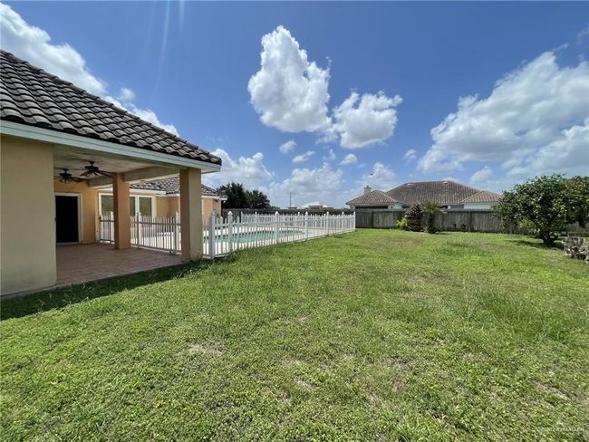 Fenced backyard featuring a ceiling fan and a patio | Image 17