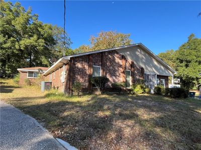 View of home's exterior featuring central AC unit and a lawn | Image 2