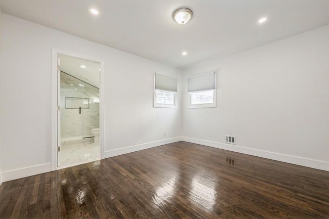 Unfurnished room featuring visible vents, baseboards, and wood finished floors | Image 5