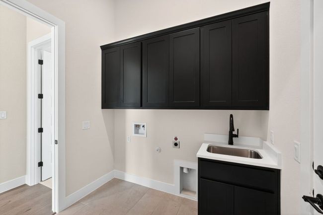 Washroom featuring hookup for a gas dryer, hookup for a washing machine, cabinet space, and electric dryer hookup | Image 27