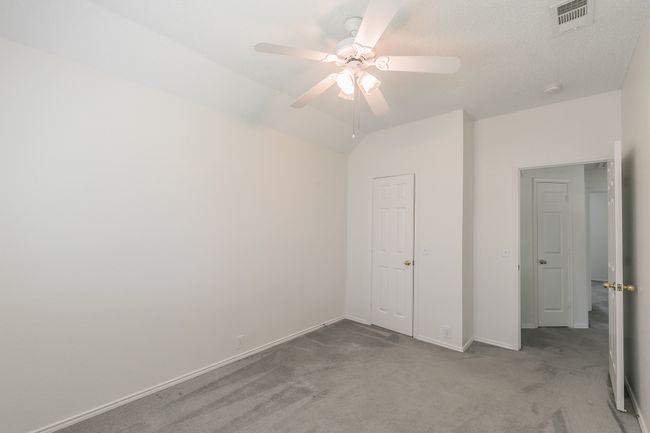 Unfurnished bedroom with baseboards, a ceiling fan, visible vents, and carpet floors | Image 18