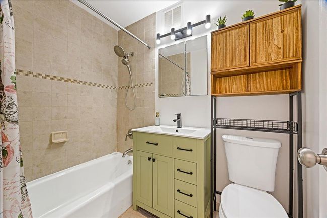 Full bathroom featuring shower / bath combo, toilet, and vanity | Image 15