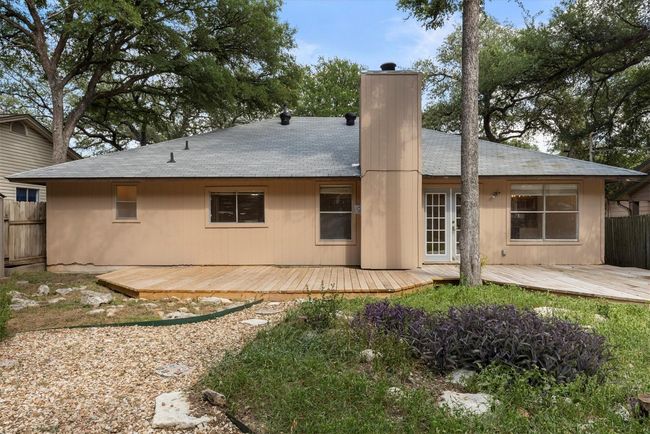 The backyard is a peaceful retreat, with lovely landscaping and mature trees that provide plenty of shade and privacy | Image 21