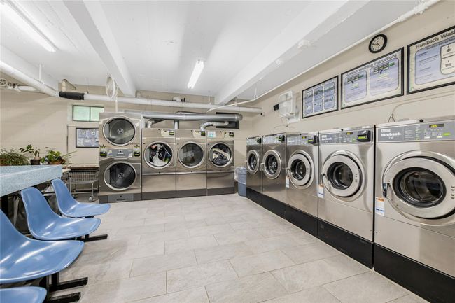 Shared laundry room featuring stacked washer / dryer, washer and clothes dryer, and tile patterned floors | Image 20