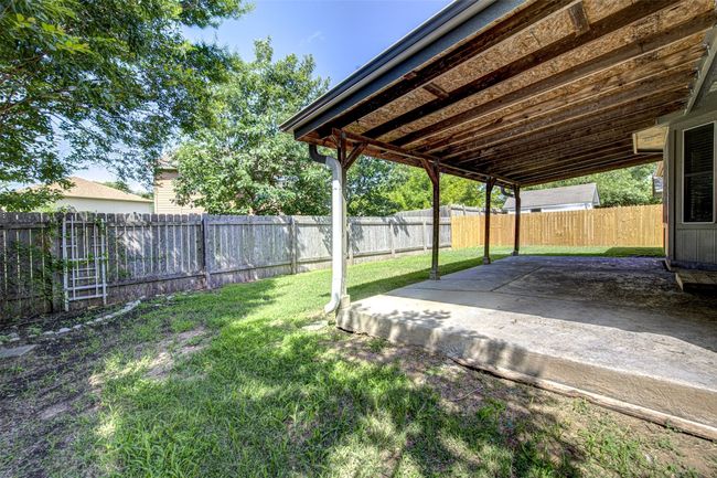 Fenced backyard with a patio area | Image 21