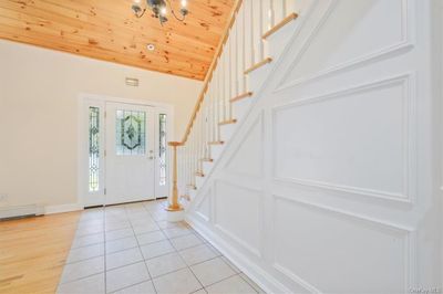 Foyer with vaulted ceiling, wooden ceiling, and light wood-type flooring | Image 3