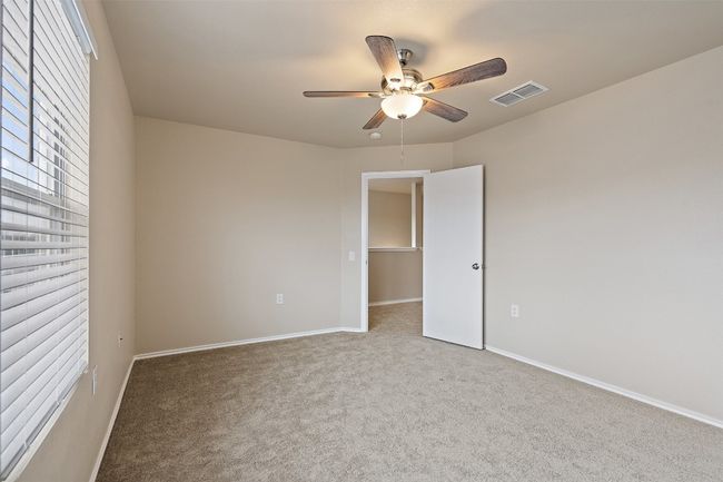 Empty room with a ceiling fan and carpet | Image 29