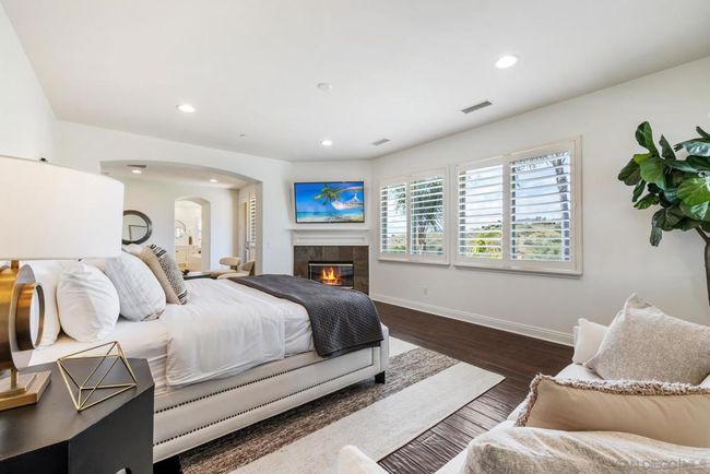 Primary bedroom with one of 3 fireplaces in the home | Image 27