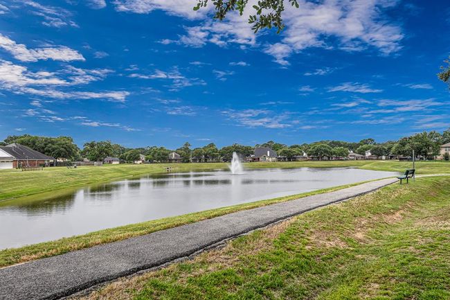 Scenic 1/3 mile paved walking trail is perfect for morning walks or evening relaxation. | Image 24