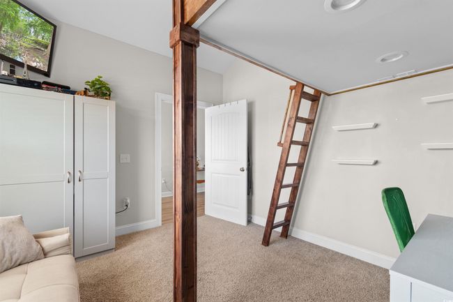 Carpeted office space featuring baseboards and lofted ceiling | Image 27