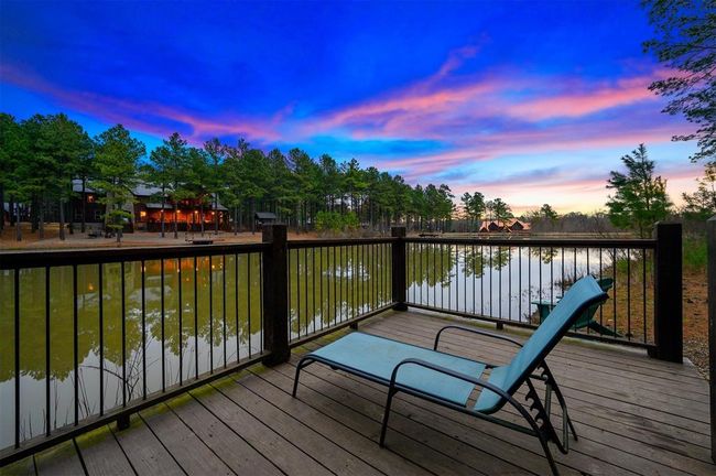Deck at dusk featuring a water view | Image 4