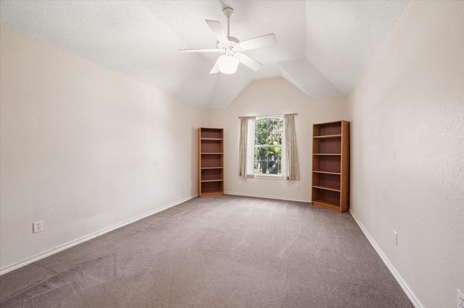 Secondary bedroom with vaulted ceiling, walk-in closet and plenty of space to create a kid-friendly retreat. | Image 37