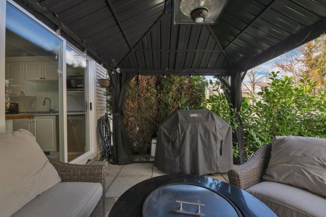 View of patio featuring a sink, a gazebo, a grill, and central air condition unit | Image 21