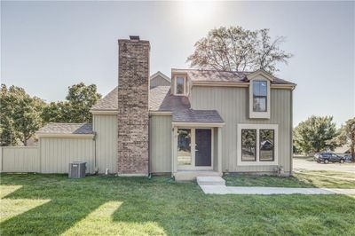 View of front of house featuring a front lawn and central AC | Image 3