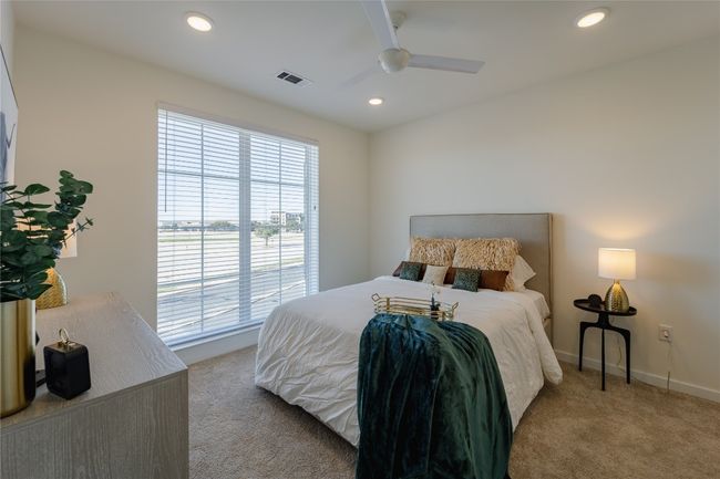 Bedroom featuring a ceiling fan, baseboards, carpet flooring, visible vents, and recessed lighting | Image 5
