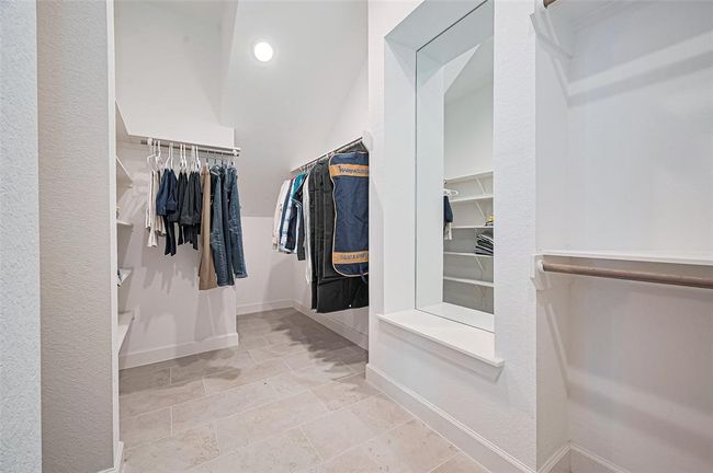 The expansive walk-in closet - thoughtfully designed for both style and function, it provides plenty of space to organize wardrobes, accessories, and more with ease | Image 24