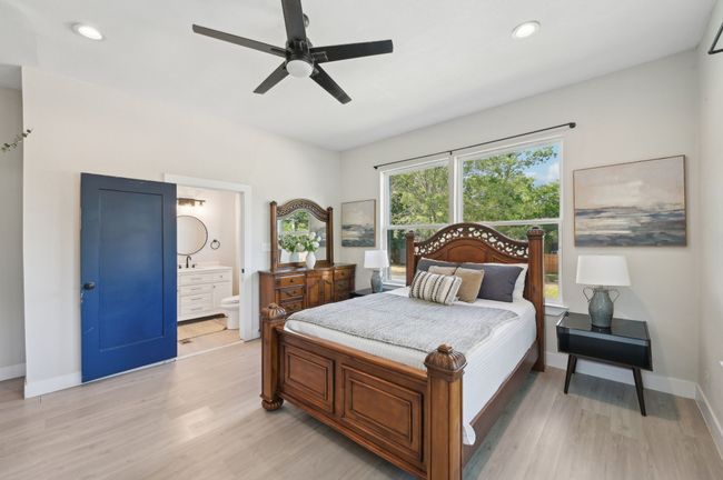 Bedroom with light wood-style flooring, baseboards, ensuite bath, recessed lighting, and a ceiling fan | Image 30