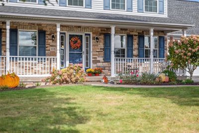 Stacked stone, vinyl and covered front porch make this front porch a welcoming point to the home. | Image 2