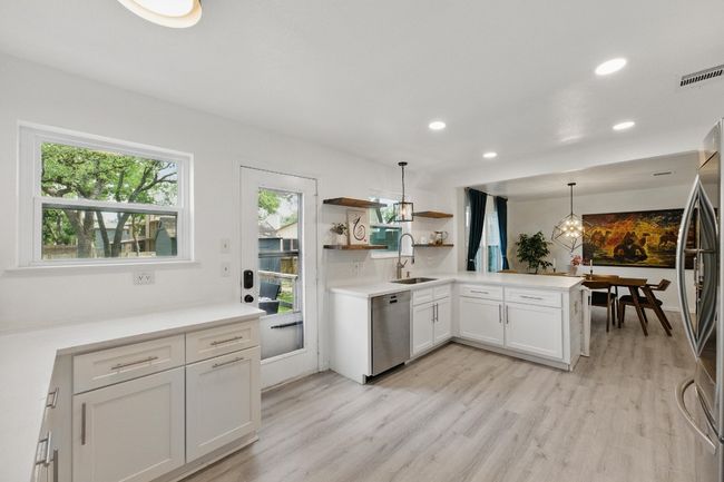 A spacious open layout creates a perfect flow from kitchen to living and dining areas for easy entertaining. | Image 13