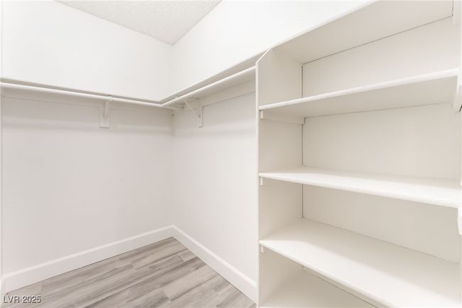 Walk in closet with light wood finished floors | Image 17