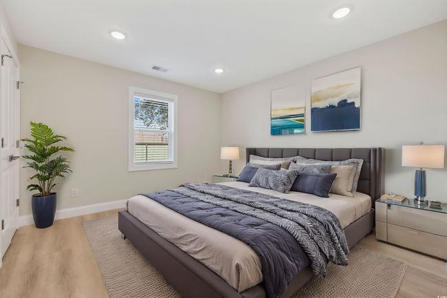 Bedroom with light wood finished floors, recessed lighting, and baseboards | Image 22