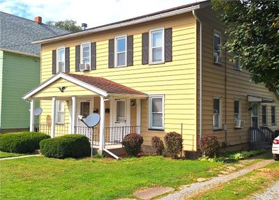 Great curb appeal with vinyl siding, shutters, and replacement windows. Well-groomed yard and lansdcaping. | Image 1