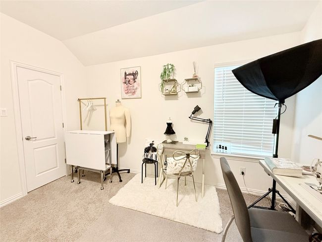 Bedroom that can also offer a home office featuring carpet floors and lofted ceiling | Image 33