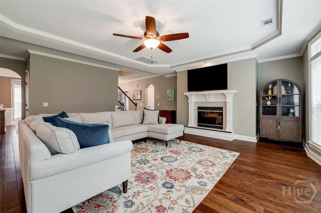 Large well lit living room with fireplace. | Image 10