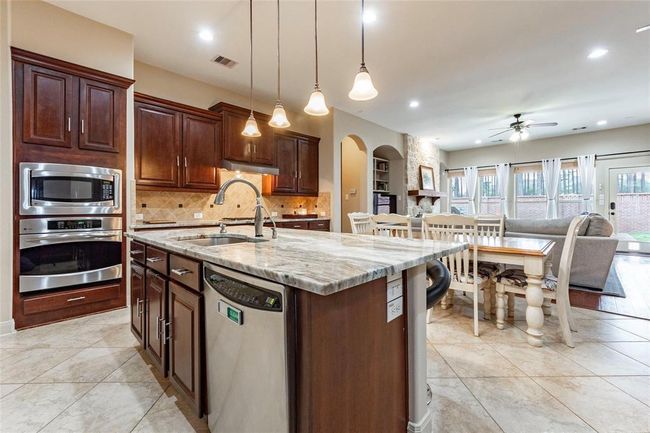 Kitchen opens up to the breakfast area and family room. | Image 26