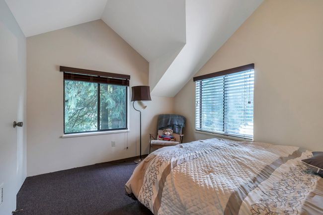 Bedroom with carpet flooring, multiple windows, and lofted ceiling | Image 33