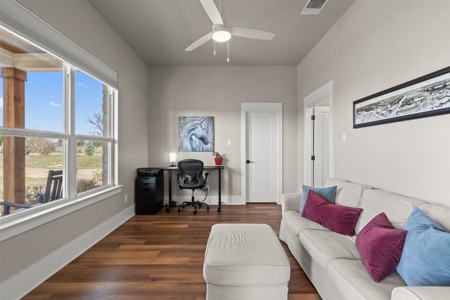 Office with a ceiling fan, dark wood-type flooring, and baseboards | Image 20