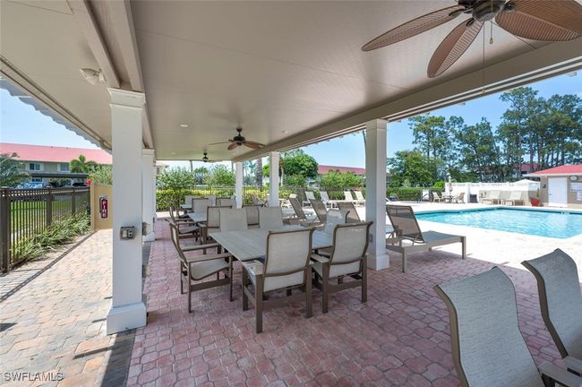 View of patio / terrace with a community pool and fence | Image 26