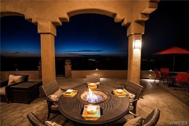 Patio at twilight featuring outdoor dining area, a patio area, and a fire pit | Image 20