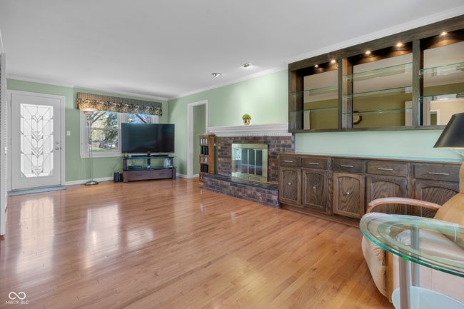 Family room with gas fireplace and hardwood floors | Image 16