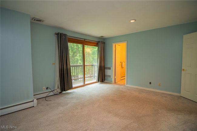 Carpeted spare room with a baseboard heating unit, baseboards, and recessed lighting | Image 10