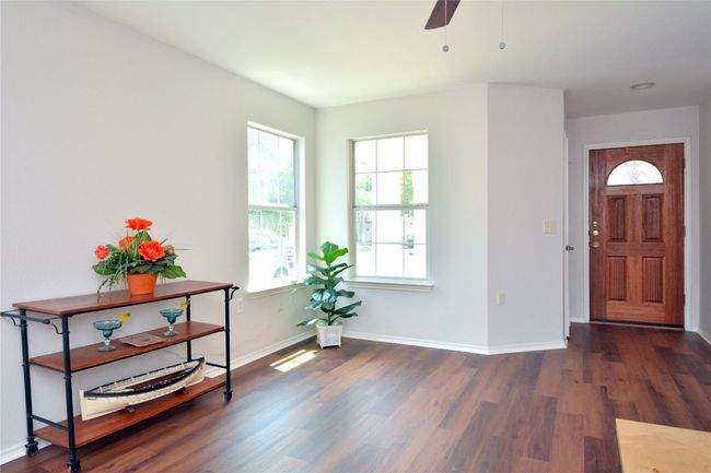 Entrance foyer with wood finished floors, baseboards, and a ceiling fan | Image 7