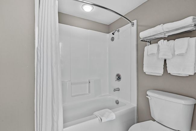 Full bath featuring toilet and shower / bath combination with curtain | Image 27