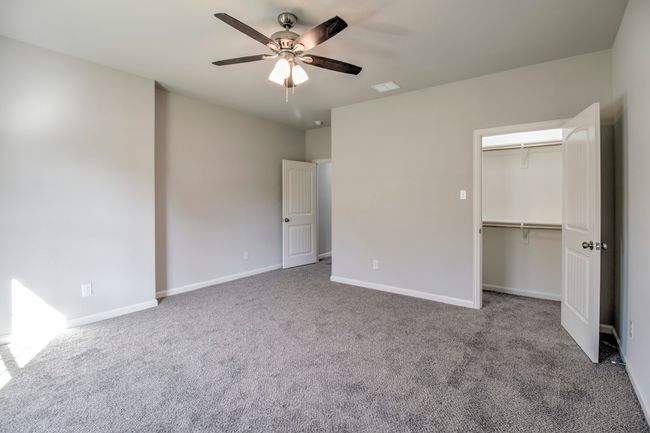 Unfurnished bedroom featuring carpet, a ceiling fan, and a closet | Image 10