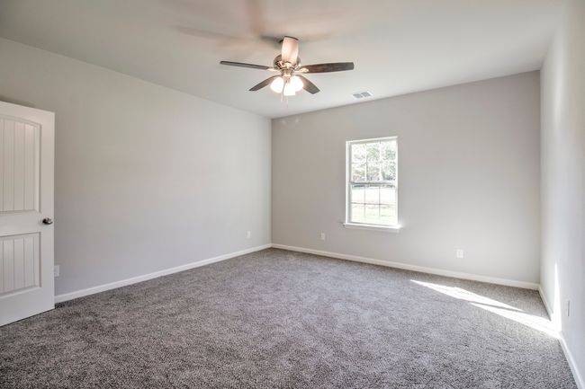 Spare room featuring ceiling fan and carpet floors | Image 13