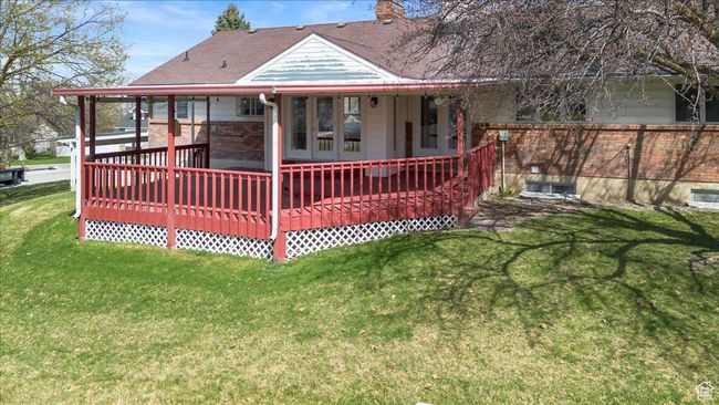 Rear view of property with brick siding, a chimney, and a lawn | Image 36
