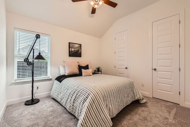 Carpeted bedroom featuring lofted ceiling and ceiling fan | Image 19