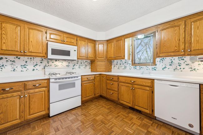 Spacious main level kitchen with matching appliances and ample storage space | Image 6