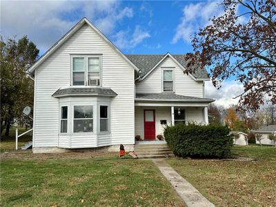 View of front featuring a covered porch and front lawn | Image 1