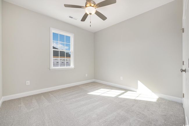Carpeted spare room with ceiling fan | Image 23