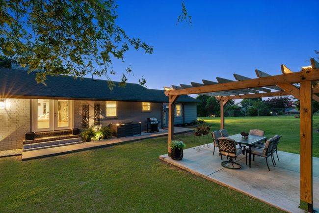 View of green lawn featuring a patio area, entry steps, and a pergola | Image 39