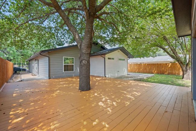 Wooden terrace with a fenced backyard | Image 21