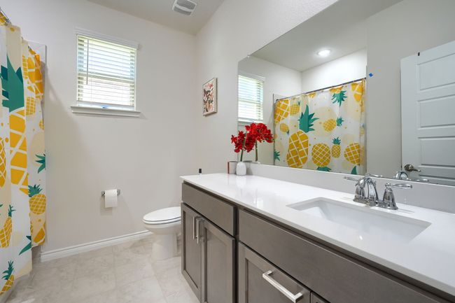 Full bathroom with vanity, toilet, healthy amount of natural light, and baseboards | Image 16