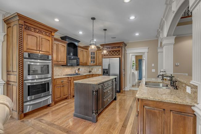 A spacious kitchen with all stainless steel appliances and custom cabinets. The heart of the house! | Image 18